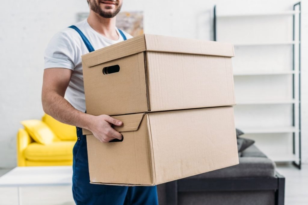 Dial A Mover removalist in uniform carrying packed boxes during a Melbourne house move